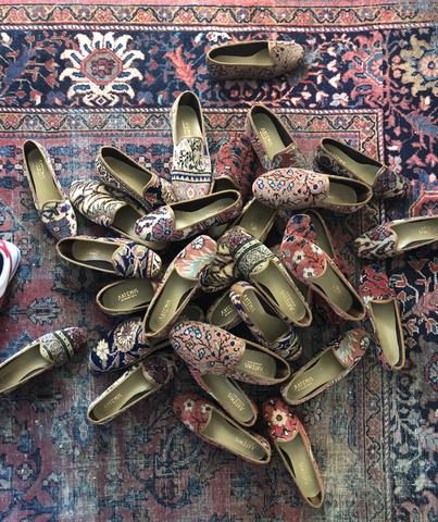 Pile of carpet shoes on an oriental carpet