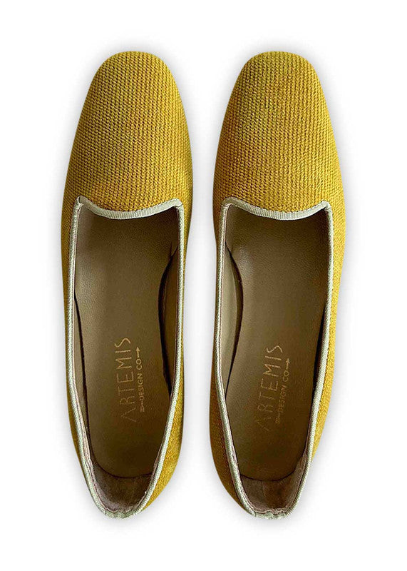 Artemis Design Co's Women's Loafers in mustard offer a bold and stylish footwear option. Crafted with meticulous attention to detail, these loafers feature a sleek design and a comfortable fit. The striking mustard hue adds a pop of color to any outfit, making them a standout choice for both casual and formal occasions. (Front View)
