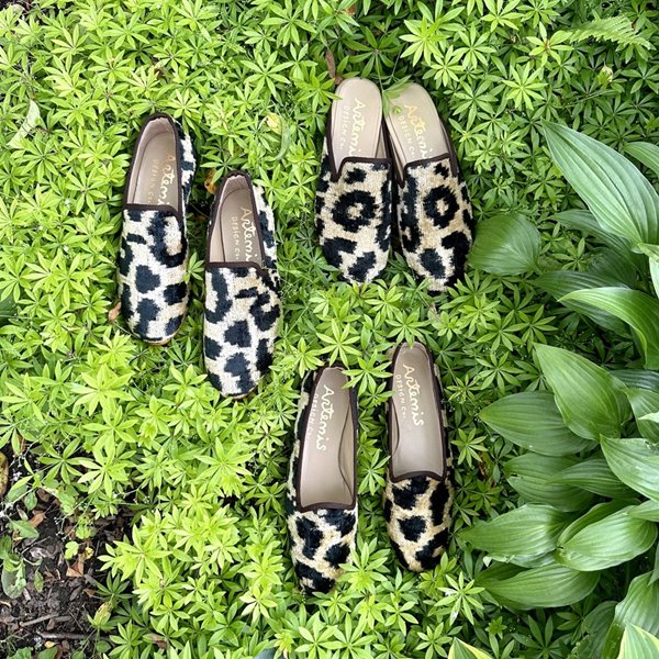 The Kilim women's leopard footwear in a sleek color combination of black and off white offers a stylish and sophisticated choice for fashion-forward women. 