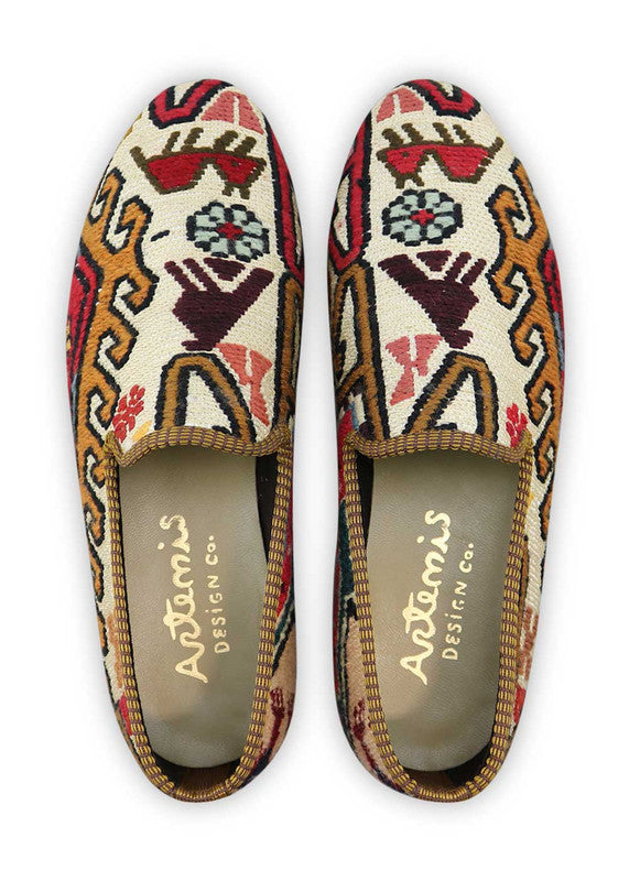 Artemis Design & Co Men's Loafers are a unique and fashionable choice, boasting a striking color combination of maroon, navy blue, khaki, white, peach, red, and green. These loafers are expertly crafted, often incorporating handwoven kilim textiles in this vibrant and diverse palette.  (Front View)