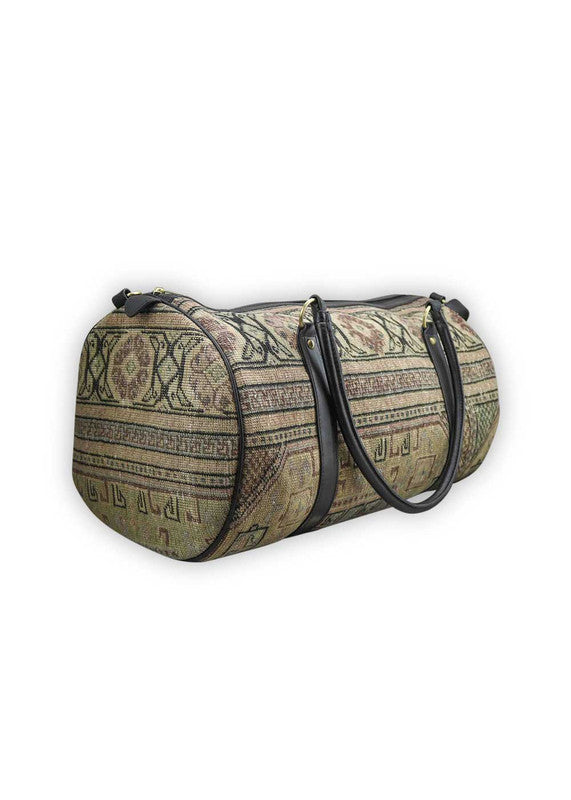 The Artemis Design & Co Travel Duffle Bag exudes timeless elegance with a sophisticated color palette of peach, brown, khaki, cream, and grey. Meticulously crafted, this duffle bag seamlessly blends warm and neutral tones, offering a chic and versatile travel companion. The interplay of colors, from the soft peach and khaki to the rich browns and creams, harmonized by the subtle greys, adds a touch of modern flair. (Side View)