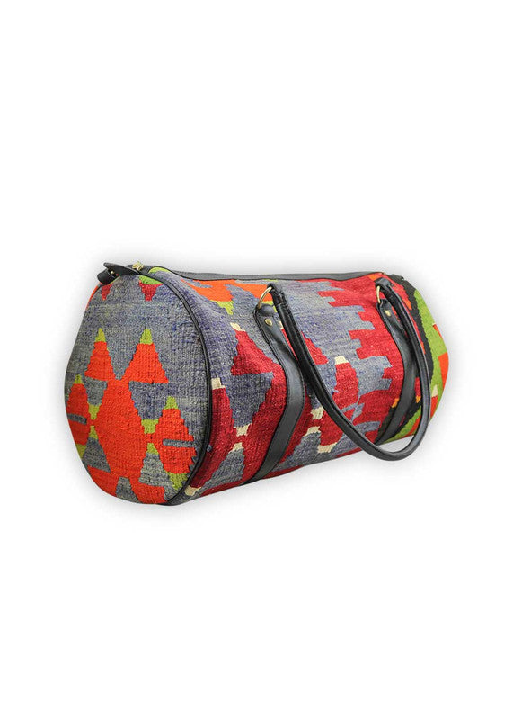 The Artemis Design & Co Travel Duffle Bag is a vibrant and stylish companion, featuring a lively color palette of red-orange, mustard, blue, red, white, and green. Meticulously crafted, this duffle bag seamlessly blends warm and bold tones, creating a versatile and eye-catching accessory for your travels. The dynamic interplay of colors, from the fiery red-orange and mustard to the classic red, and the crisp white and refreshing greens, adds a modern and energetic flair.(Side View)
