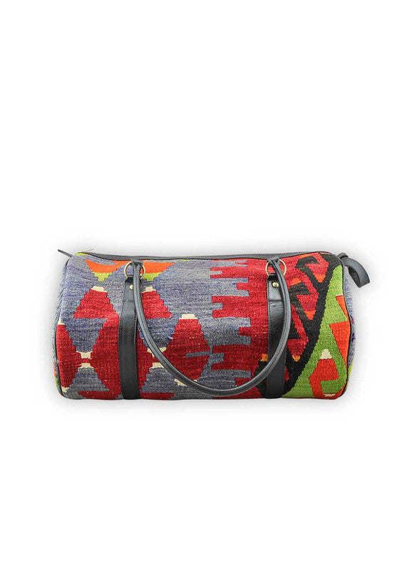 The Artemis Design & Co Travel Duffle Bag is a vibrant and stylish companion, featuring a lively color palette of red-orange, mustard, blue, red, white, and green. Meticulously crafted, this duffle bag seamlessly blends warm and bold tones, creating a versatile and eye-catching accessory for your travels. The dynamic interplay of colors, from the fiery red-orange and mustard to the classic red, and the crisp white and refreshing greens, adds a modern and energetic flair. (Front View)