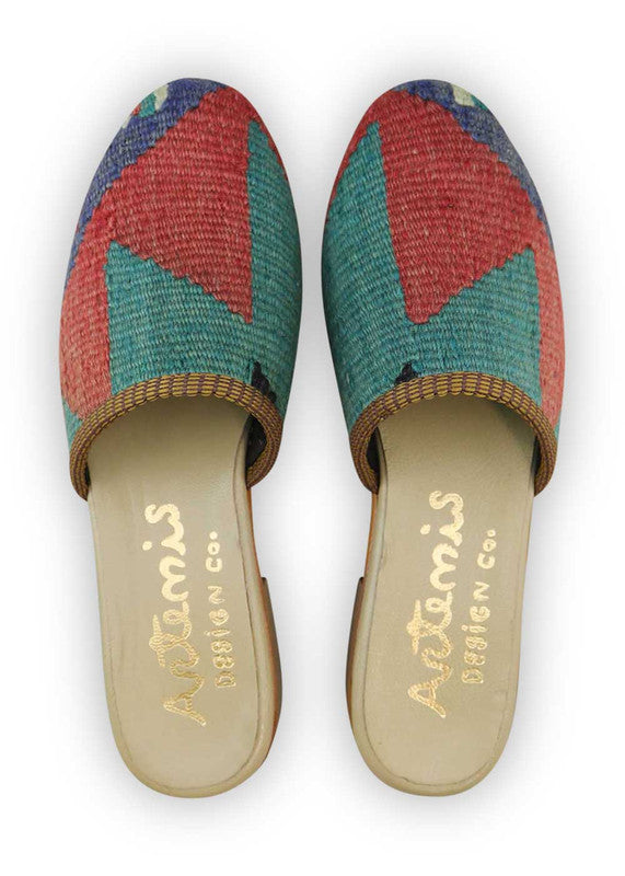 The Artemis Women's Slides exhibit an alluring color combination of red, teal, blue, and black. These slides bring together a striking mix of vibrant and classic hues, resulting in a chic and versatile appearance. (Front View)