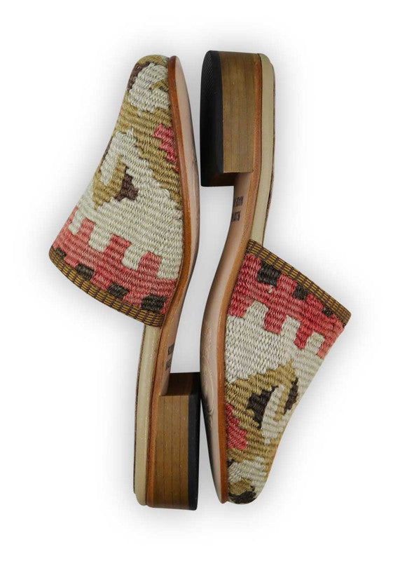 The Artemis Women's Slides feature a captivating color combination of brown, red, white, khaki, and black. These slides offer a striking blend of warm and neutral tones, creating a versatile and stylish look. Whether you're lounging at home or stepping out for a casual occasion, these slides are the perfect choice.  (Side View)