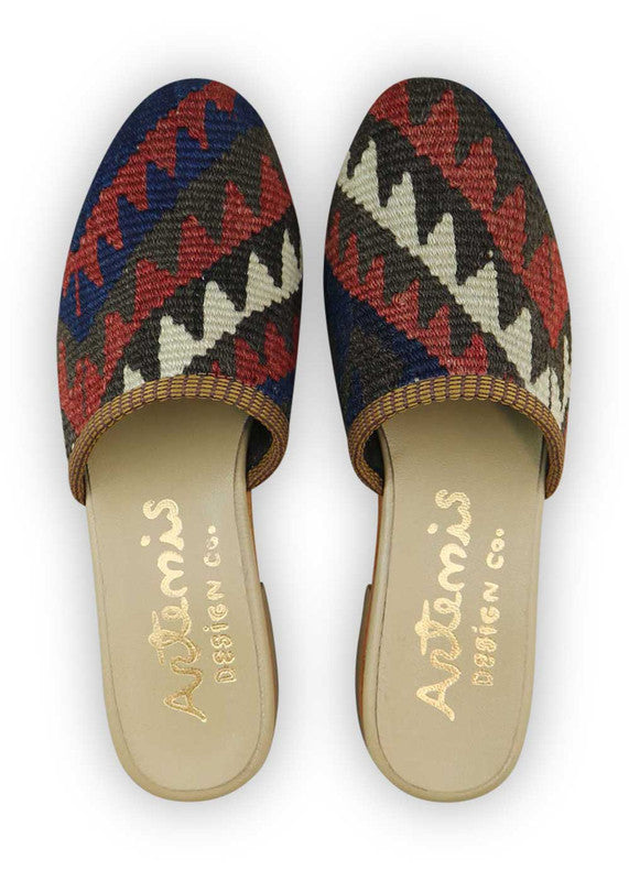 The Artemis Women's Slides showcase a captivating color combination of navy blue, red, moss green, black, and white. These slides offer a balanced blend of bold and classic tones, creating a lively and versatile look. Whether you're relaxing at home or stepping out for a casual outing, these slides are the perfect choice. (Front View)