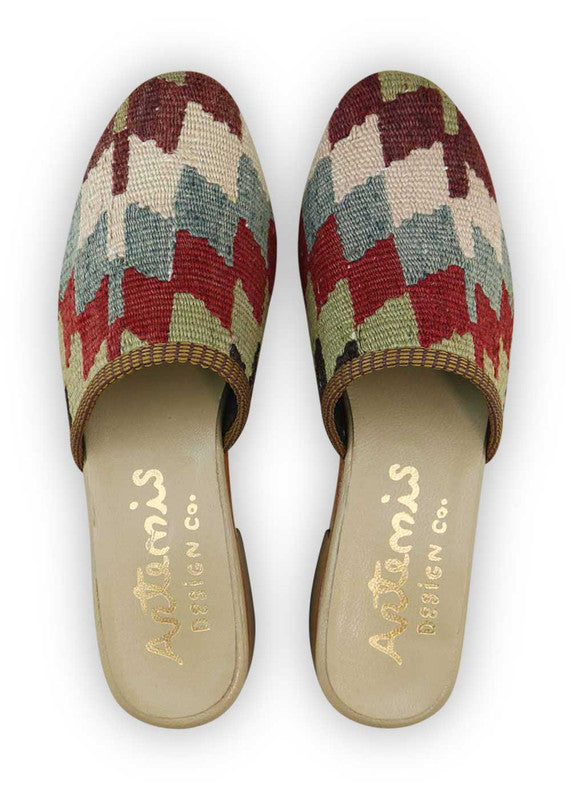 The Artemis Women's Slides showcase a vibrant color palette featuring brown, white, blue, red, green, and black. These slides offer a captivating blend of rich and classic tones, creating a lively and versatile look. Whether you're unwinding at home or stepping out for a casual occasion, these slides are the perfect choice. (Front View)