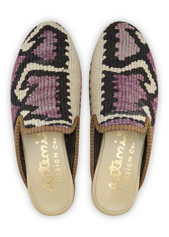 The Artemis Design& Co Women's Slippers in black, white, violet, and light orange are a stylish and comfortable choice for women. Made with high-quality materials and attention to detail, these slippers offer durability and long-lasting comfort. (Front View)