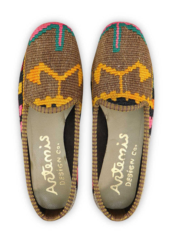 The Artemis Women's Loafer showcases a captivating color combination of grey, black, fuschia, blue, yellow, orange, brown, teal, and maroon. These loafers present a vibrant and eye-catching mix of hues, making them a true fashion statement.  (Front View)