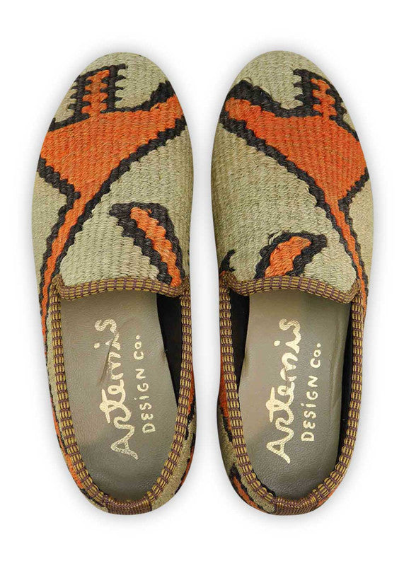 The Artemis Women's Smoking Shoe features a striking color combination of khaki, orange, and black. These smoking shoes offer a bold and vibrant mix of earthy and contrasting tones, creating a chic and eye-catching look. Whether you're dressing up for a special occasion or seeking a comfortable yet stylish option for everyday wear, these shoes are the perfect choice. (Front View)