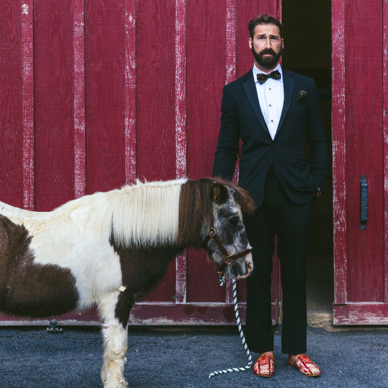 Photographer Nick Mele wearing Artemis Sumak Loafers in a tuxedo with a miniature pony