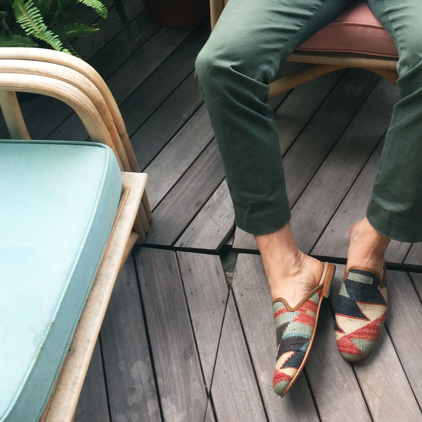 The Artemis Men's Slippers feature a captivating color combination of green, red, khaki, and black. These slippers offer a vibrant mix of bold and earthy tones, creating a stylish and eye-catching look. (Front View)
