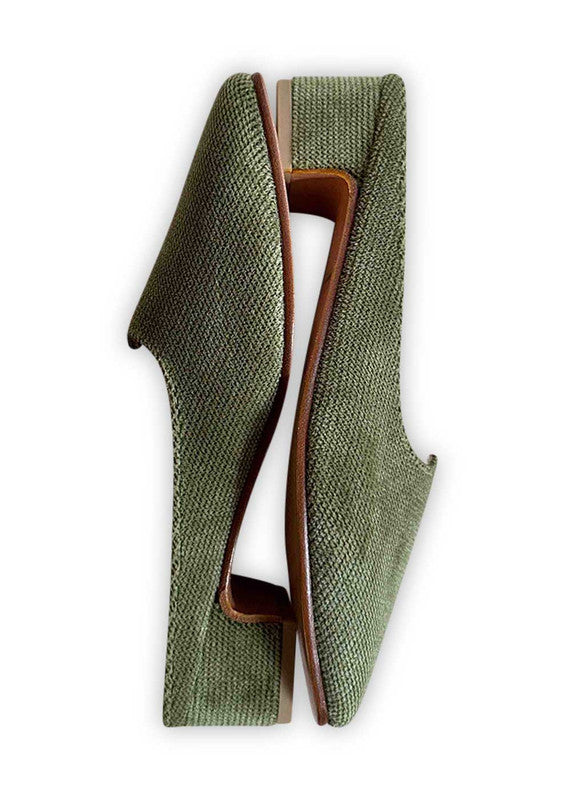 Introducing Artemis Design Co Women's Mules in a captivating shade of green. These stylish mules effortlessly fuse elegance with comfort, making them the perfect choice for any occasion. Crafted with meticulous attention to detail, they boast a timeless design that complements a variety of outfits. Step into sophistication and elevate your ensemble with Artemis Design Co Women's Mules in this refreshing green hue. (Side View)