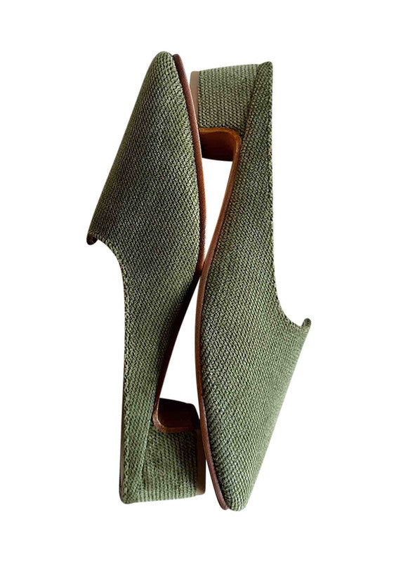 Introducing Artemis Design Co Women's Mules in a captivating shade of green. These stylish mules effortlessly fuse elegance with comfort, making them the perfect choice for any occasion. Crafted with meticulous attention to detail, they boast a timeless design that complements a variety of outfits. (Side View)