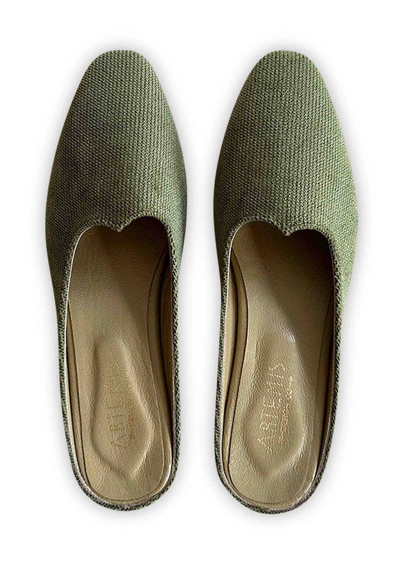 Introducing Artemis Design Co Women's Mules in a captivating shade of green. These stylish mules effortlessly fuse elegance with comfort, making them the perfect choice for any occasion. Crafted with meticulous attention to detail, they boast a timeless design that complements a variety of outfits. (Front View)