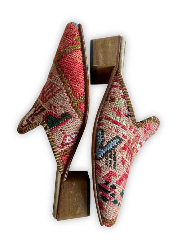 Elevate your style with Artemis Design Co Women's Mules, featuring a captivating color palette of red, khaki, pink, blue, black, brown, white, and green. These mules blend vibrant hues seamlessly for a chic and versatile look. Whether you're dressing up for a night out or adding flair to your everyday ensemble, these meticulously crafted mules offer both comfort and sophistication. (Side View)