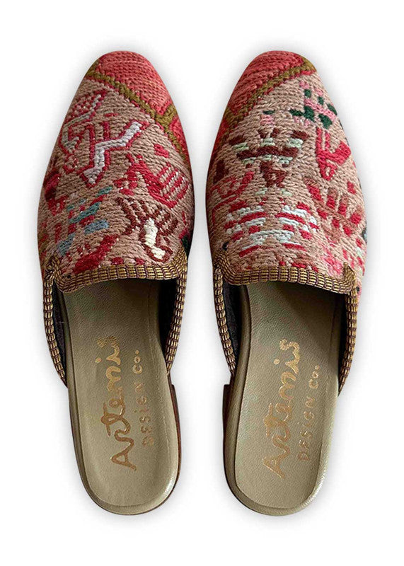 Elevate your style with Artemis Design Co Women's Mules, featuring a captivating color palette of red, khaki, pink, blue, black, brown, white, and green. These mules blend vibrant hues seamlessly for a chic and versatile look. Whether you're dressing up for a night out or adding flair to your everyday ensemble, these meticulously crafted mules offer both comfort and sophistication. (Front View)