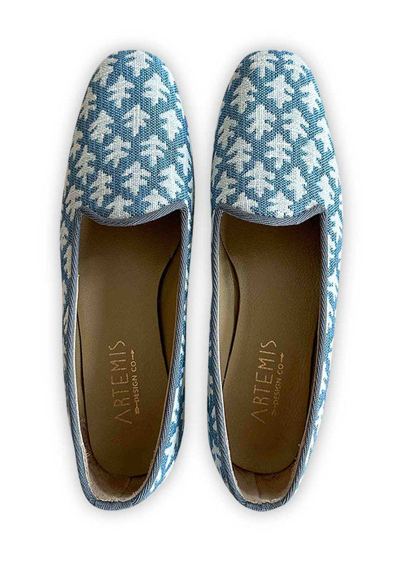 Elevate your ensemble with Artemis Design Co Women's Loafers featuring a refreshing color combination of white and blue. Crafted with meticulous attention to detail, these loafers offer a perfect blend of style and comfort. The crisp white hue complements the serene blue accents, creating a chic and versatile footwear option. (Front View)