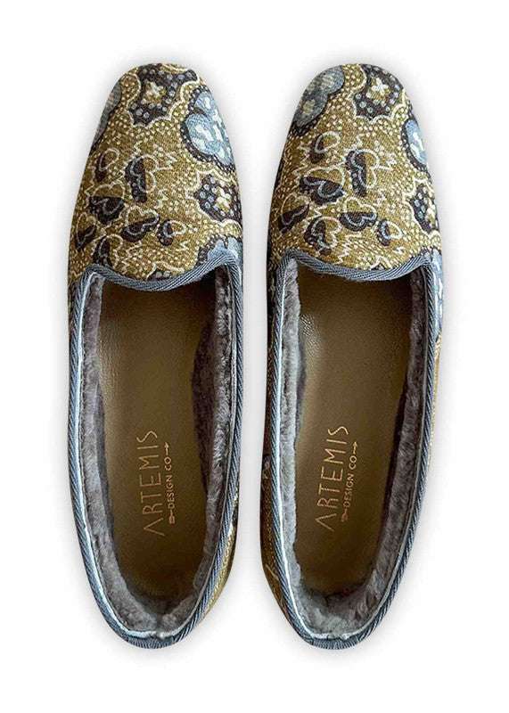 The Artemis Design Co Women's Loafers boast a stylish color combination of grey, khaki, blue, white, and brown. These impeccably crafted loafers offer both elegance and versatility. With their timeless design and sophisticated palette, they effortlessly complement a wide range of outfits. (Front View)