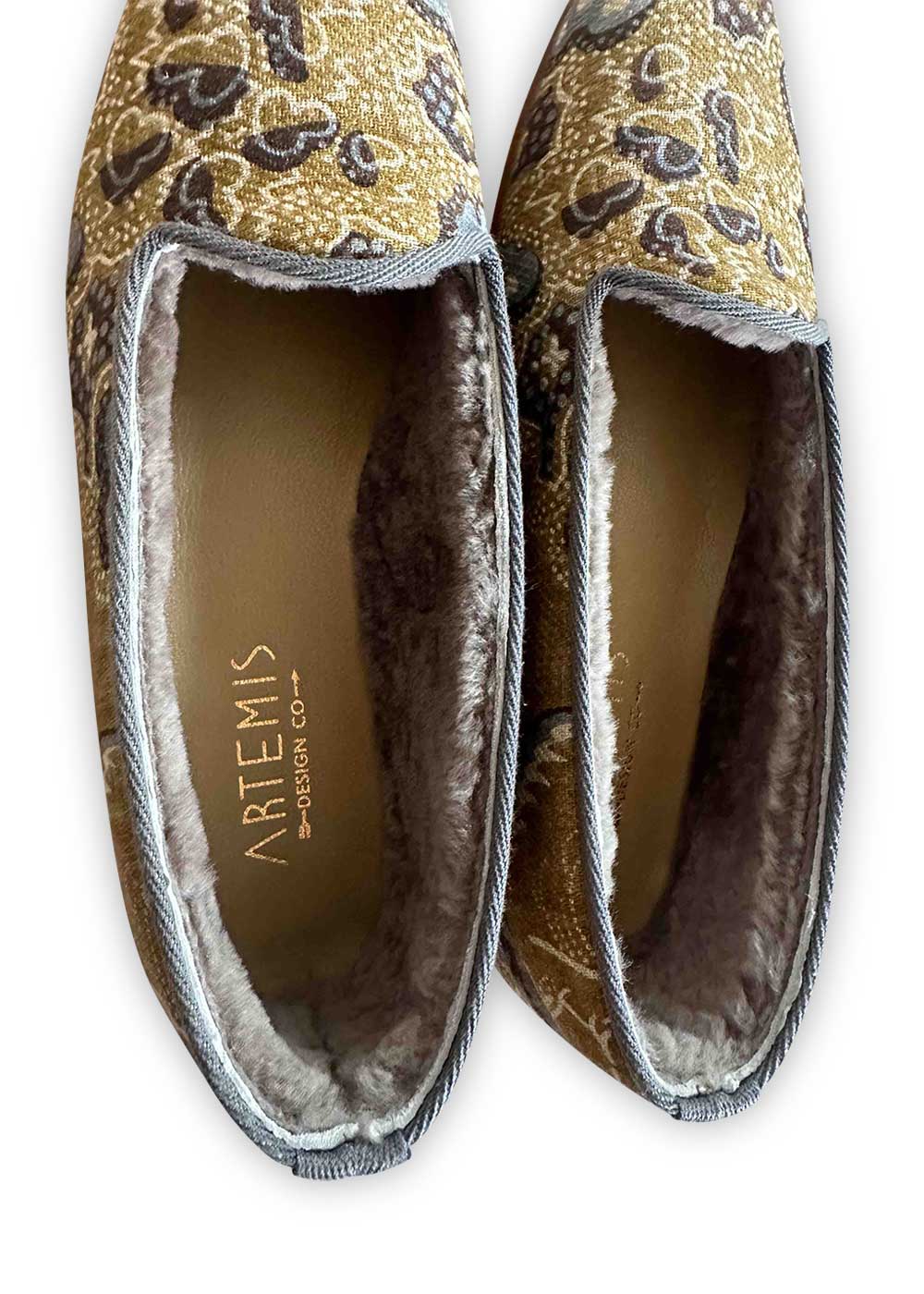 Artemis Design Co's Women's patterned cotton & shearling loafers in a color combination of grey, khaki, white, and dark grey are a stylish and cozy footwear option. The unique blend of colors creates a sophisticated yet versatile look that complements a variety of outfits. These loafers feature a patterned cotton upper for visual interest and are lined with plush shearling for warmth and comfort. (Front View)