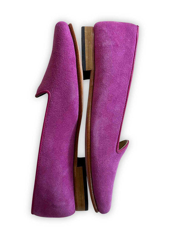 Artemis Design Co's Women's Suede Loafers in fuchsia offer a bold and vibrant twist to a classic style. Crafted with luxurious suede material, these loafers exude sophistication and charm. The striking fuchsia hue adds a pop of color to any outfit, making them an eye-catching choice for both casual and formal occasions. With their sleek silhouette and impeccable craftsmanship, these loafers are a statement piece that effortlessly elevates any ensemble. (Side View)