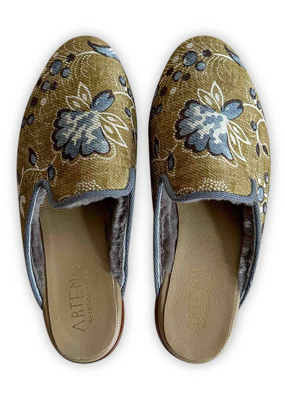Artemis Design Co's Women's Slippers present a charming color fusion of khaki, blue, white, and brown, crafting a delightful blend of style and comfort. Meticulously crafted, these slippers feature a plush interior for cozy warmth, paired with a sleek exterior adorned with an enchanting pattern that seamlessly combines the soothing tones.  (Front View)