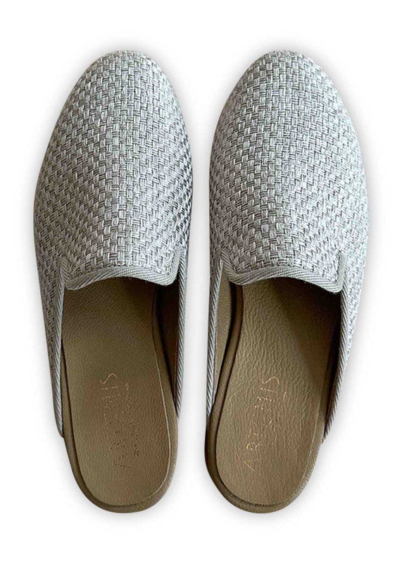 Artemis Design Co's Women's Slippers in elegant grey offer a sophisticated and versatile footwear option. Crafted with attention to detail and comfort in mind, these slippers feature a plush interior for cozy warmth. Their sleek and minimalist design, in a timeless grey hue, ensures effortless pairing with any loungewear ensemble. (Front View)