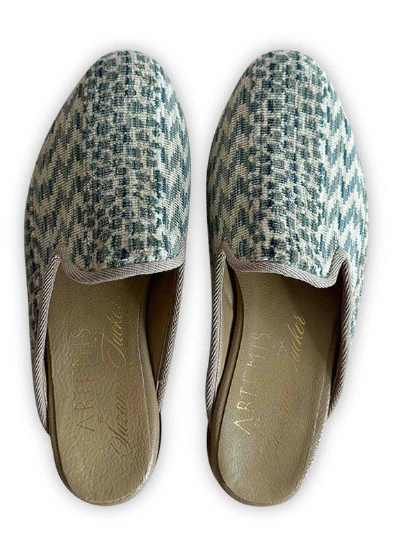 Artemis Design Co's Women's Slippers offer a serene aesthetic with their color combination of blue and white. These slippers are designed for comfort and style, featuring a plush interior for cozy warmth and a sleek exterior adorned with a captivating pattern that seamlessly blends the tranquil hues of blue and white. With meticulous craftsmanship and attention to detail, these slippers provide both relaxation and elegance, perfect for unwinding at home in luxurious comfort. (Front View)