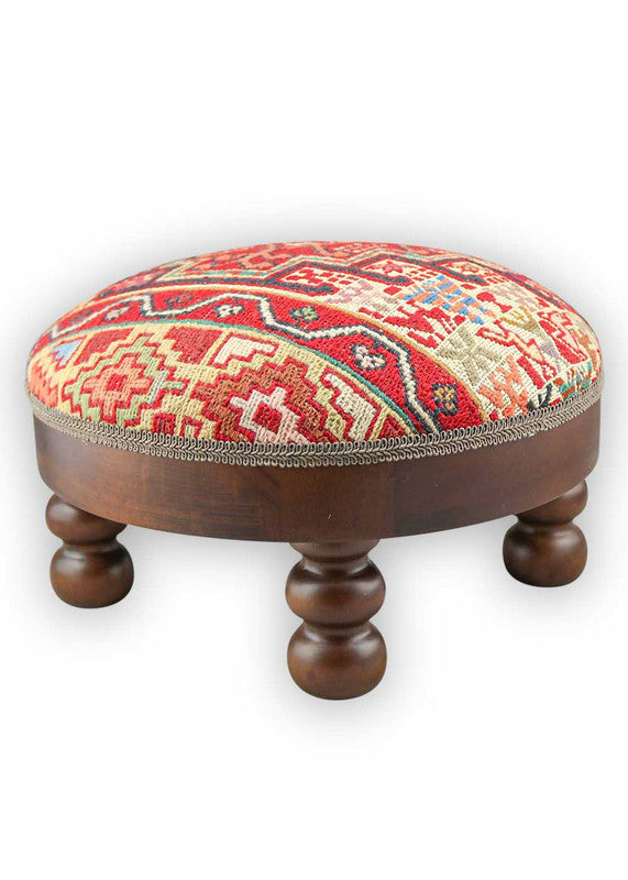 The Artemis Design & Co Footstool is a charming and versatile accent piece, showcasing a delightful color palette of red, white, cream, green, peach, blue, and brown. Meticulously crafted, this footstool seamlessly blends warm and cool tones, creating a stylish and functional addition to your living space. (Side View)