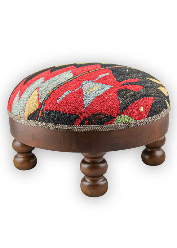 The Artemis Design & Co Footstool is a bold and stylish accent piece, featuring a captivating color combination of black, fuchsia pink, green, red, blue, peach, and cream. Meticulously crafted, this footstool seamlessly blends vibrant and neutral tones, creating a chic and eye-catching addition to your living space. (Side View)