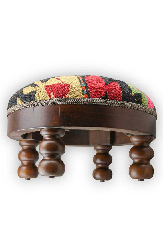 The Artemis Design & Co Footstool is a bold and stylish accent piece, featuring a captivating color combination of black, fuchsia pink, green, red, blue, peach, and cream. Meticulously crafted, this footstool seamlessly blends vibrant and neutral tones, creating a chic and eye-catching addition to your living space. (Side View)