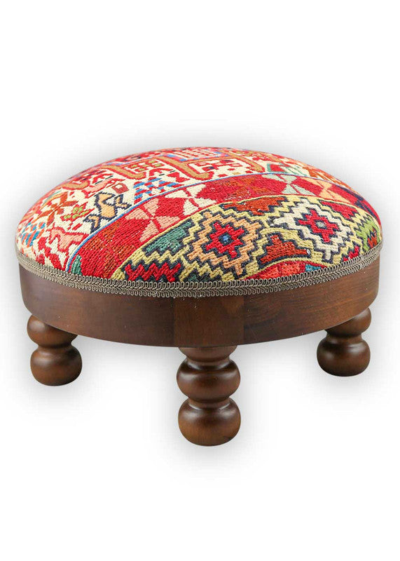 The Artemis Design & Co Footstool is a charming and versatile accent piece, showcasing a delightful color palette of red, white, cream, green, peach, blue, and brown. Meticulously crafted, this footstool seamlessly blends warm and cool tones, creating a stylish and functional addition to your living space.  (Side View)