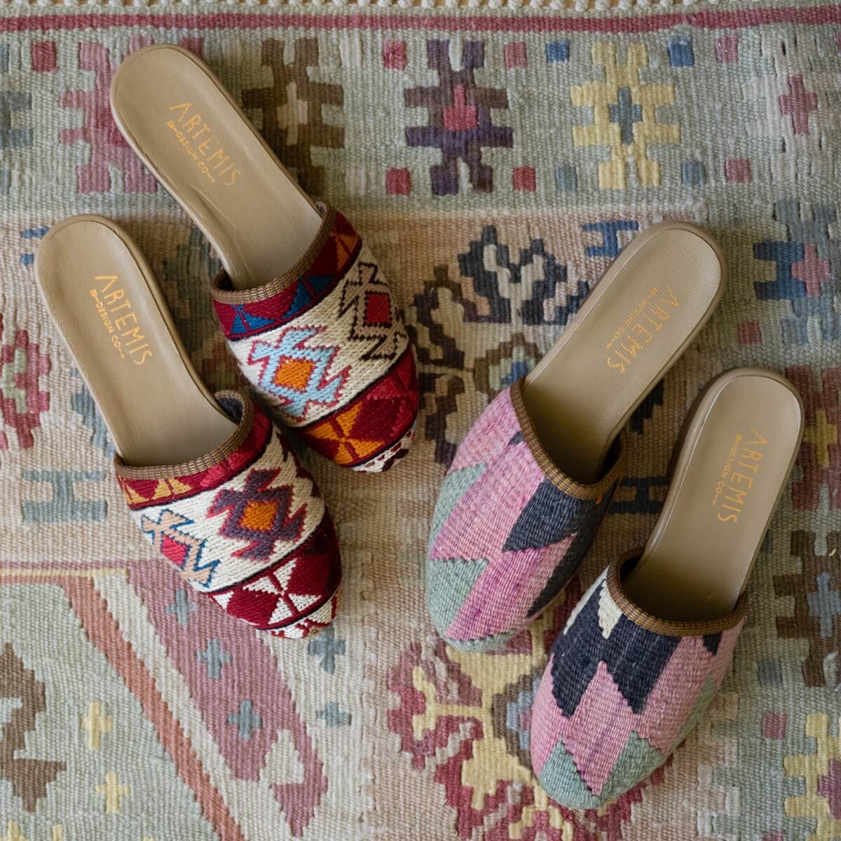 The Artemis Design Co Women's Slide boasts a vibrant and stylish color palette, featuring a dynamic combination of red, white, blue, mustard, sky blue, violet, orange, pink, grey, black, and khaki. With a design that effortlessly blends these hues, these slides offer a perfect balance of fashion and comfort, making them a versatile and eye-catching choice for any casual or outdoor occasion. (Front View)