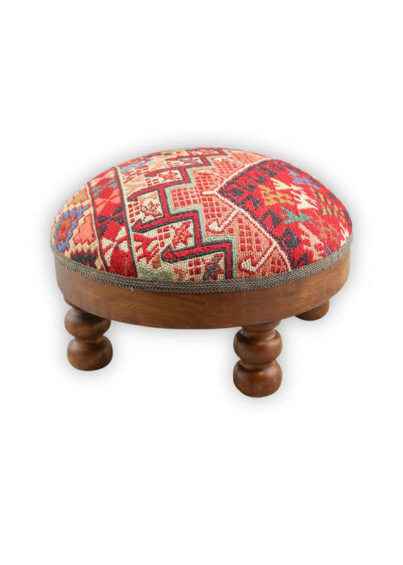 The Artemis Design & Co Foot Stool, featuring a dynamic and colorful combination of white, blue, red, black, green, orange, peach, brown, and teal, is a vibrant and eye-catching addition to your living space. This foot stool's diverse and bold color palette adds a playful and lively touch to your decor. (Side View)