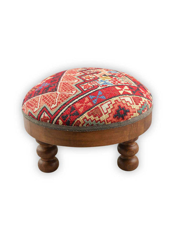 The Artemis Design & Co Foot Stool, featuring a dynamic and colorful combination of white, blue, red, black, green, orange, peach, brown, and teal, is a vibrant and eye-catching addition to your living space. This foot stool's diverse and bold color palette adds a playful and lively touch to your decor. (Front View)