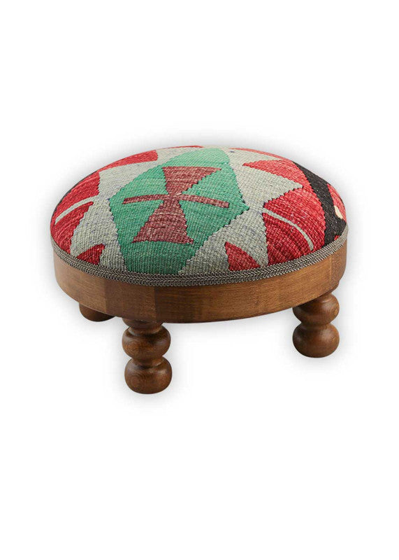 The Artemis Design & Co Foot Stool featuring a captivating color combination of black, red, green, white, red-orange, and grey is a bold and visually striking addition to any living space. This foot stool's eclectic mix of colors creates a vibrant and contemporary aesthetic that stands out in a room. (Side View)