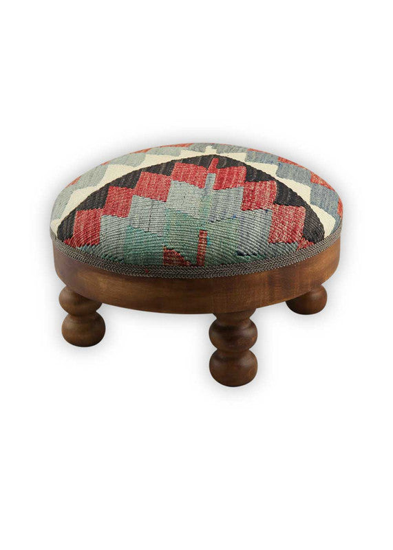 The Artemis Design & Co Foot Stool featuring a captivating color combination of black, red, green, white, red-orange, and grey is a bold and visually striking addition to any living space. This foot stool's eclectic mix of colors creates a vibrant and contemporary aesthetic that stands out in a room. 