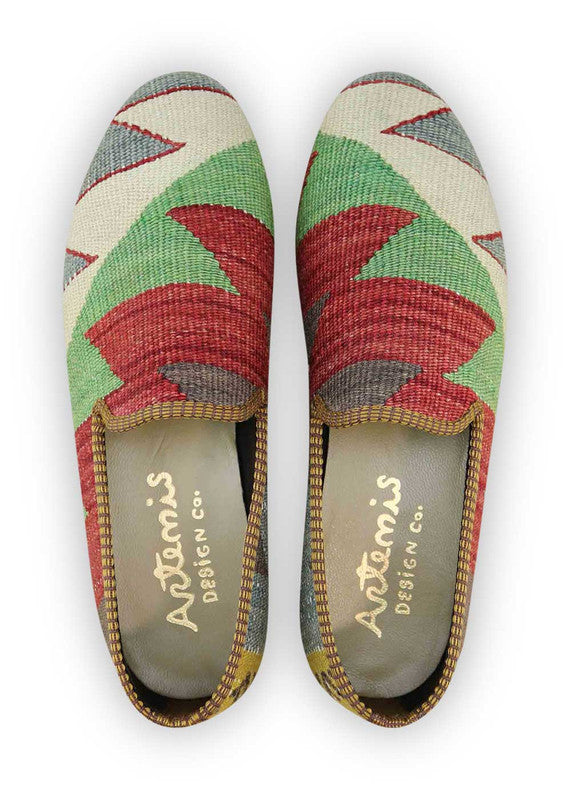 The Artemis Men's Loafers exude a captivating blend of colors, showcasing dark grey, red, green, white, grey, and mustard. These loafers seamlessly blend the richness of dark grey with the boldness of red and the freshness of green, complemented by the classic charm of white and grey, against the warm backdrop of mustard. (Front View)