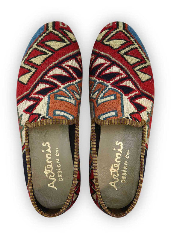 The Artemis Men's Loafers showcase a captivating mix of colors, featuring red, white, black, khaki, gray, peach, and blue. These loafers seamlessly blend the boldness of red and black with the classic charm of white and the neutral tones of khaki and gray, complemented by the softness of peach and the calming shades of blue. (Front View)