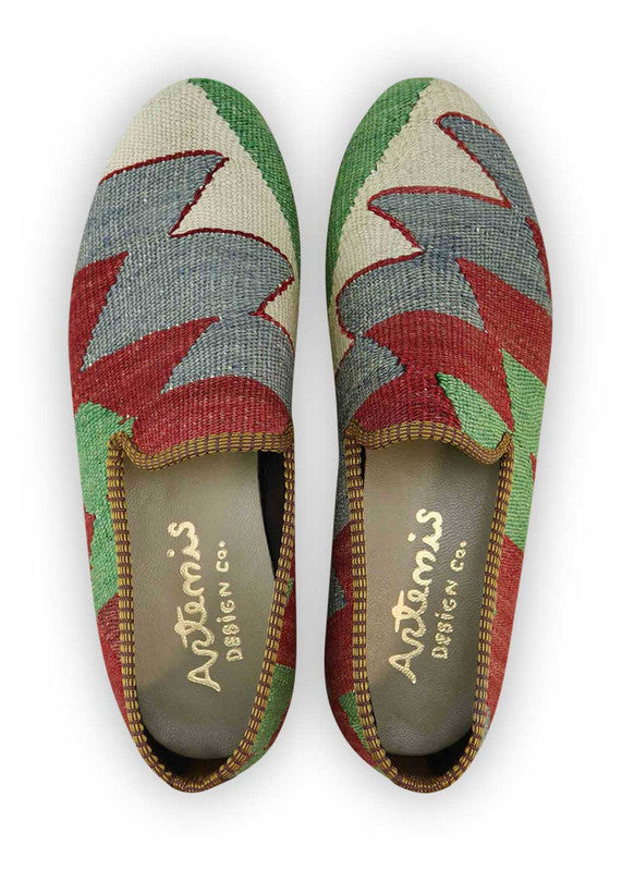 The Artemis Men's Loafers exude vibrant charm, showcasing a color palette that combines green, white, blue, and red. These loafers seamlessly blend the freshness of green and white with the calming tones of blue, accented by the boldness of red.  (Front View)