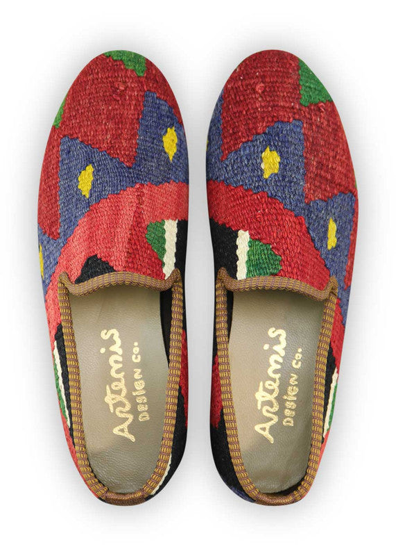 Artemis Design Co. Men's Loafers offer a vibrant blend of colors, featuring striking combinations of red, green, blue, yellow, black, and white. Meticulously crafted with attention to detail, these loafers seamlessly merge bold hues with classic style. Perfect for adding a pop of personality to any ensemble, they are suitable for both casual and semi-formal occasions. (Front View)