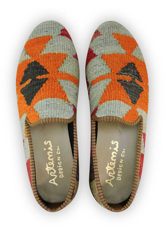 The Artemis Men's Loafers exhibit a harmonious blend of colors, featuring shades of grey, red, dark grey, brown, beige, and orange. These loafers seamlessly combine the understated allure of grey and dark grey with vibrant accents of red and orange, complemented by the earthy tones of brown and beige. (Front View)