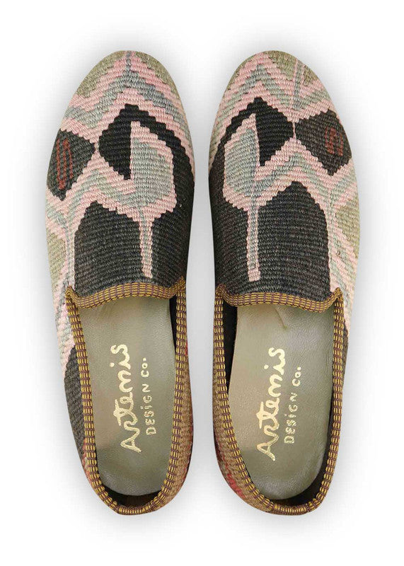 The Artemis Men's Loafers showcase a refined harmony of colors, including black, brown, pink, grey, and red. These loafers skillfully blend the timeless allure of black and brown with delicate accents of pink and the understated tones of grey and red. The result is a balanced and sophisticated color palette that exudes both confidence and style.  (Front View)