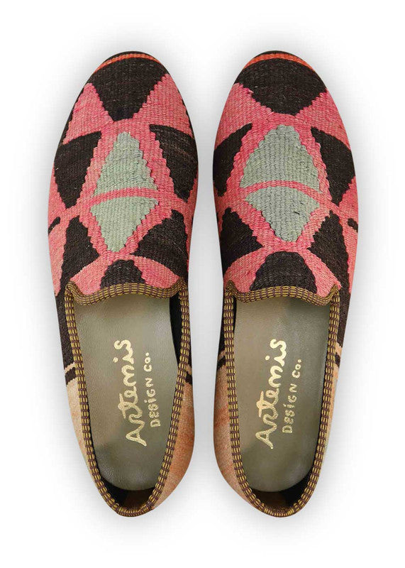 The Artemis Men's Loafers are a fusion of contemporary style, boasting a color palette that intertwines fuchsia, black, peach, and grey. These loafers seamlessly blend the boldness of fuchsia with the timeless appeal of black, softened by delicate peach hues and complemented by versatile shades of grey.  (Front View)