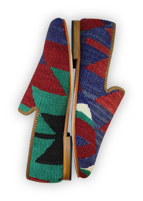 The Artemis Men's Loafers present a tasteful fusion of blue, red, green, and black. These loafers artfully combine rich blue and bold red accents, complemented by subtle touches of vibrant green and timeless black. The result is a harmonious blend of colors that exudes both confidence and style. (Side View)
