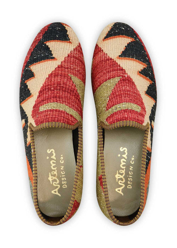 Artemis Design & Co Men's Loafers are a bold and stylish choice, featuring a striking color combination of orange, black, peach, red, and brown. These loafers are meticulously crafted, often incorporating handwoven kilim textiles in this dynamic and contrasting palette. (Front  View)