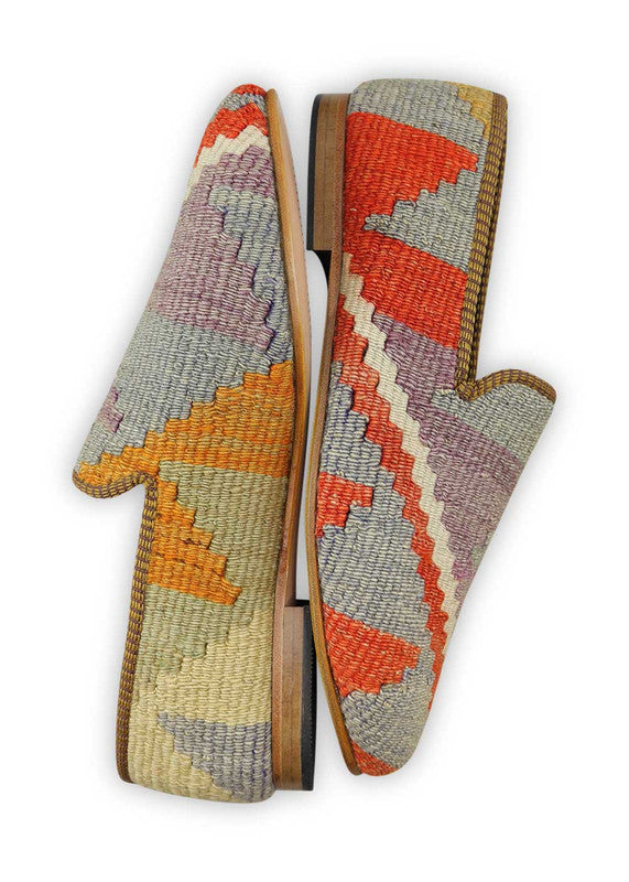 Artemis Design & Co Men's Loafers are a vibrant and stylish choice, featuring an engaging color combination of red, orange, white, mustard, grey, cream, and lilac. These loafers are meticulously crafted, often incorporating handwoven kilim textiles in this diverse and eye-catching palette. (Side View)