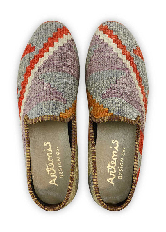 Artemis Design & Co Men's Loafers are a vibrant and stylish choice, featuring an engaging color combination of red, orange, white, mustard, grey, cream, and lilac. These loafers are meticulously crafted, often incorporating handwoven kilim textiles in this diverse and eye-catching palette. (Front View)