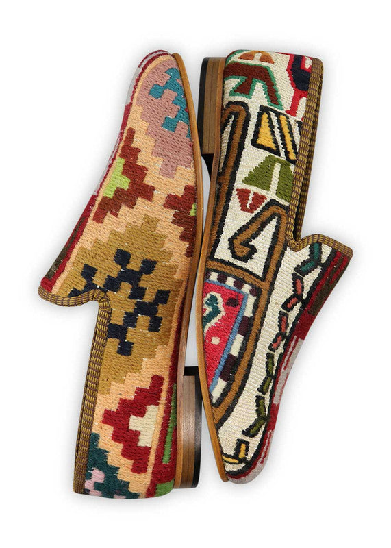Artemis Design & Co Men's Loafers are a unique and fashionable choice, boasting a striking color combination of maroon, navy blue, khaki, white, peach, red, and green. These loafers are expertly crafted, often incorporating handwoven kilim textiles in this vibrant and diverse palette.  (Side View)