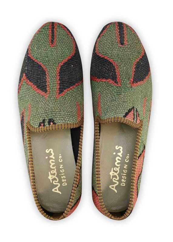 The Artemis Men's Loafers exhibit a bold and striking color blend, featuring black, red-orange, and dark green. These loafers expertly combine the classic allure of black with the vibrant energy of red-orange and the rich depth of dark green. The result is a captivating and daring color combination that exudes confidence and individuality. (Front View)